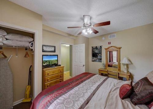 a bedroom with a bed and a ceiling fan at WP231 Old Mill Overlook in Pigeon Forge