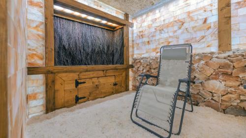 a chair sitting in a room with a window at Sand Dunes, Sun & Snow in Dziwnów