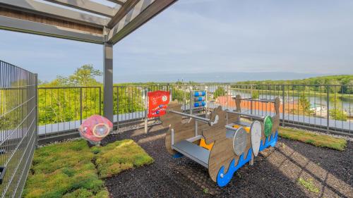 a balcony with a playground with a fence at Sand Dunes, Sun & Snow in Dziwnów