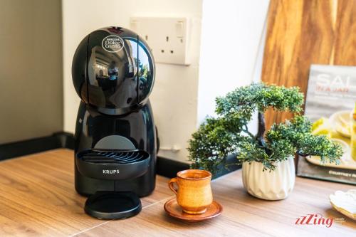 a black blender sitting on top of a wooden table at Taz-Zuzu, The Gozo Retreat for Dreamers & Doers in Sannat