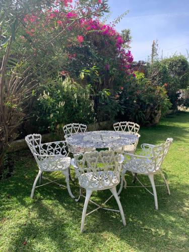 a table and two chairs with a table and flowers at Hotel Posada Kamol Bey in Panajachel