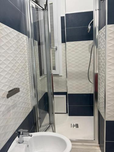 a bathroom with a sink and a shower at Javelin's Accomodation in Tropea