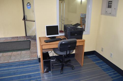 an office with a desk with a computer and a printer at Days Inn by Wyndham Grand Island in Grand Island