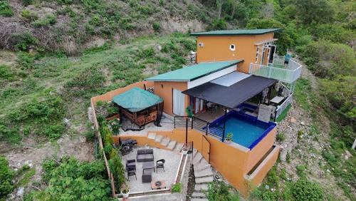 an overhead view of a house on a hill at Barney's Pointe Beach House, Batangas City in Batangas City