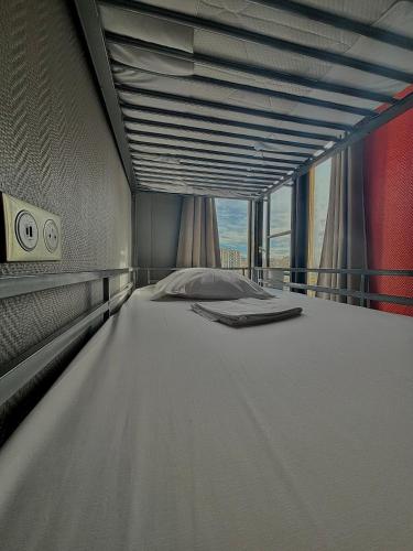 a large bed in a room with a large window at Peace & Love Hostel in Paris
