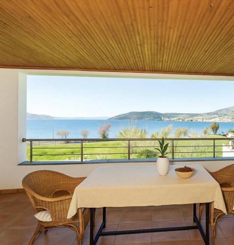 a dining room with a table and a large window at Sea & Salt ,Pelion,Agria Volos in Agria