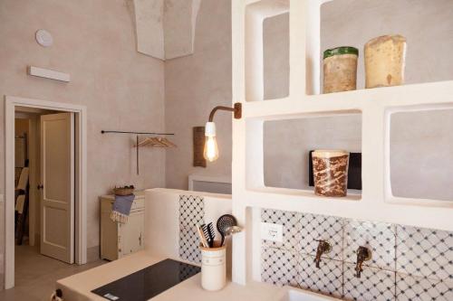 a kitchen with white cabinets and a counter top at Masseria Borgo Sentinella in Torre dell'Orso