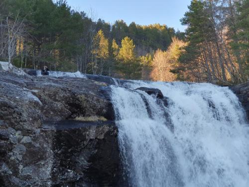 a waterfall on the side of a river at Feriehus Rodal med Båt in Rodal