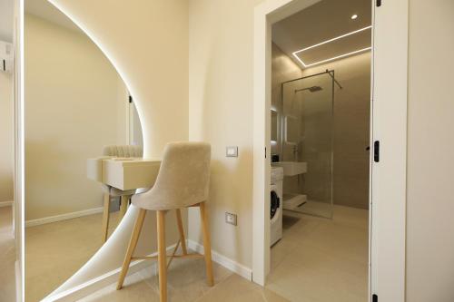 a room with a table and a chair and a mirror at Villa Christianna Free Parking in Vlorë