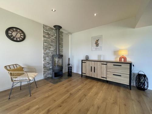 a living room with a dresser and a clock on the wall at Perry in Mialos
