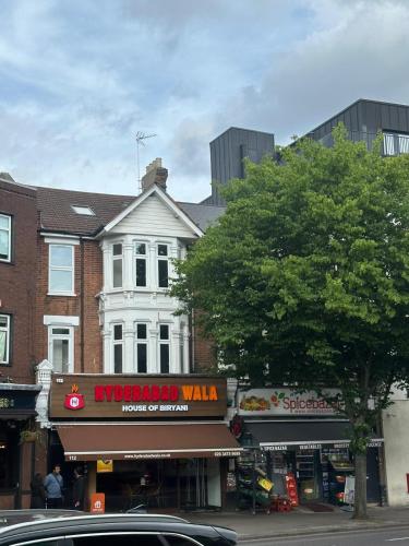 a city street with shops and a building at Sterling Bed & Breakfast in Ilford