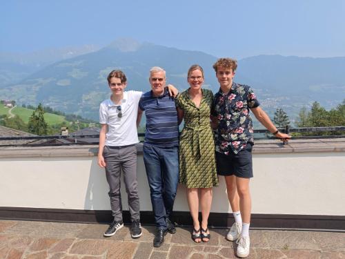 a group of people posing for a picture on a roof at Pension Apartments Pardell in Castelbello-ciardes