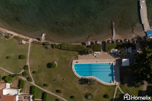 an aerial view of a yard with a swimming pool at Veya Suite - Private Beach & Pools in Eretria