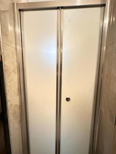 a glass shower door in a bathroom at Social House Istanbul in Istanbul