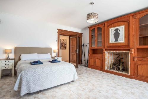 a bedroom with a bed and a fireplace at Casa Sussa in Tías