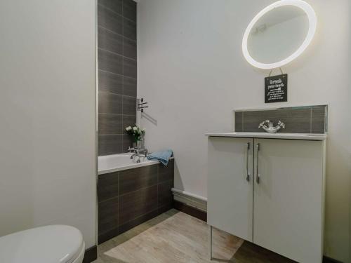 a bathroom with a toilet and a sink and a mirror at 3 Bed in Portreath 89492 in Camborne