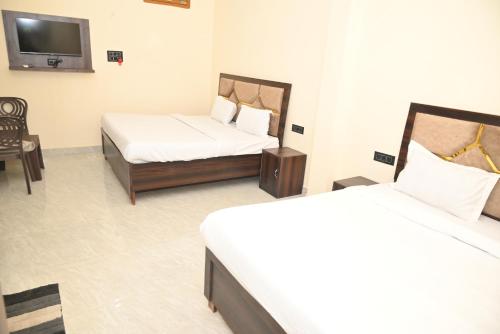 Postel nebo postele na pokoji v ubytování De Classico Residency