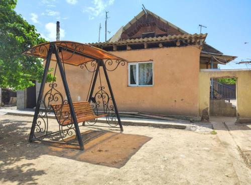 a bench sitting in front of a house at Guesthouse Koguchkon in Kara-Talaa