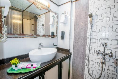 a bathroom with a sink and a mirror at Gagal Home - Powai Suite in Mumbai