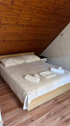 a bed in a room with a wooden ceiling at Old Town Primošten in Primošten