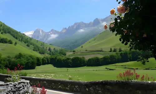 a view of a green field with mountains in the background at Gite Bellevue Accous in Accous