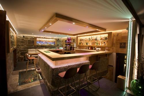 a bar in a restaurant with stools around it at Quinta de CasalMato in Resende