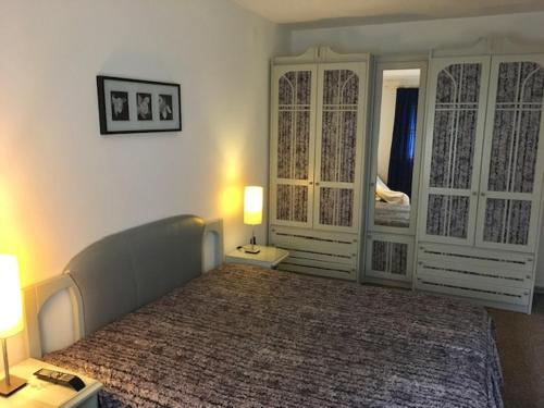 a bedroom with a large bed and two lamps at Balaton Vendégház Keszthely in Keszthely