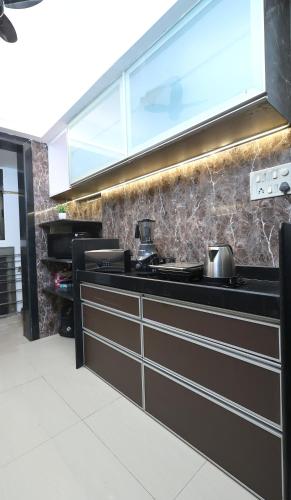 a kitchen with a sink and a counter top at Gagal Home - Powai Suite in Mumbai