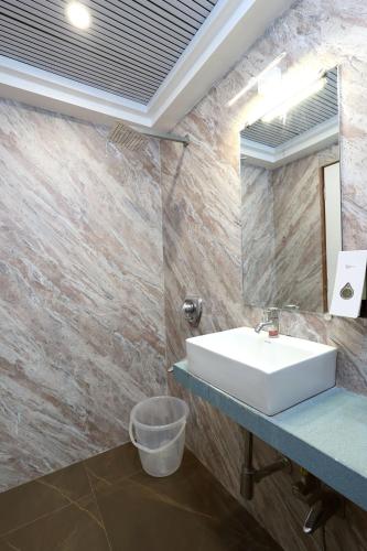 a bathroom with a sink and a mirror at Gagal Home - Powai Suite in Mumbai