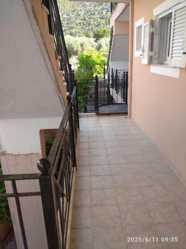 a tiled hallway of a building with a balcony at Lihas Studios in Agios Georgios