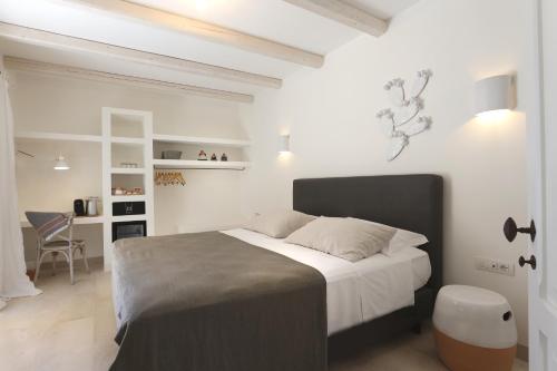 a bedroom with a large bed and a desk at Masseria Borgo Sentinella in Torre dell'Orso