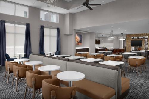 a restaurant with tables and chairs and a bar at Homewood Suites by Hilton Metairie New Orleans in Metairie