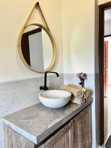 a bathroom with a sink and a mirror at Bukawa Residences Balangan in Jimbaran