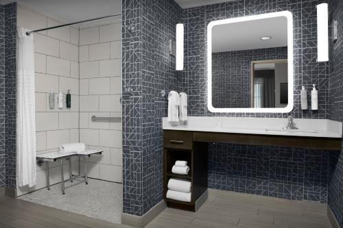 a bathroom with a sink and a mirror at Homewood Suites by Hilton Metairie New Orleans in Metairie
