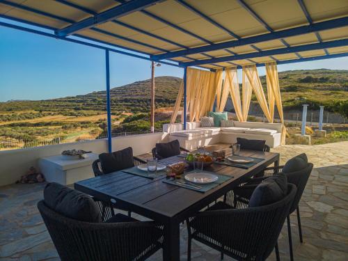 a dining table and chairs on a patio at Sugarstone House in Adamas