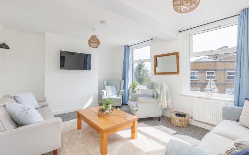 a living room with a couch and a table at Heart of Cowes - 10 Guests, 200m to Town, Sea View in Cowes