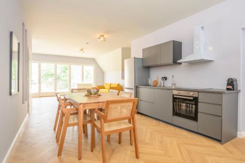 Una cocina y un comedor con mesa y sillas. en Palais Palffy Suits, en Viena