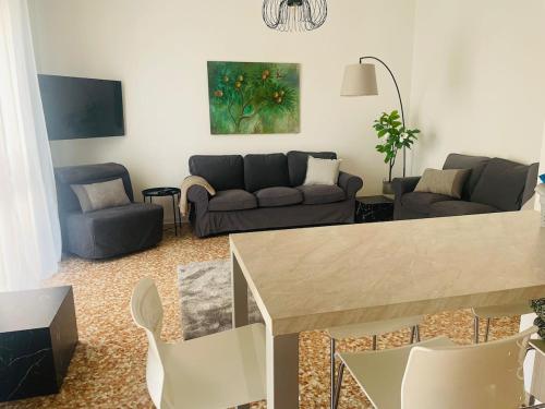 a living room with a couch and a table at Baveno Lakeview Escape in Baveno