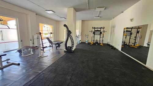 a room with a gym with tread machines and a chair at Boho Breeze Aheloy in Aheloy