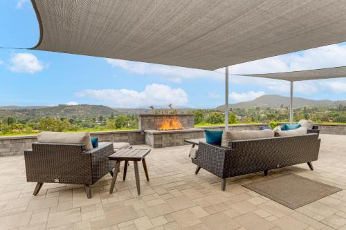 a patio with two chairs and a fire pit at 2 Mi to Lake Poway Mtn-View Escape with Patio! in Poway