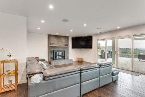 a living room with a couch and a fireplace at 2 Mi to Lake Poway Mtn-View Escape with Patio! in Poway