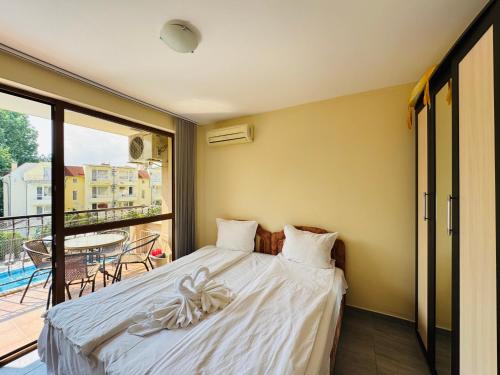 a bedroom with a bed and a balcony at KALIA C9 One Bedroom Apartment in Sunny Beach