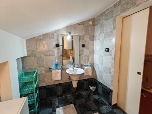 a bathroom with a sink and a mirror at Villa Finera in Premantura