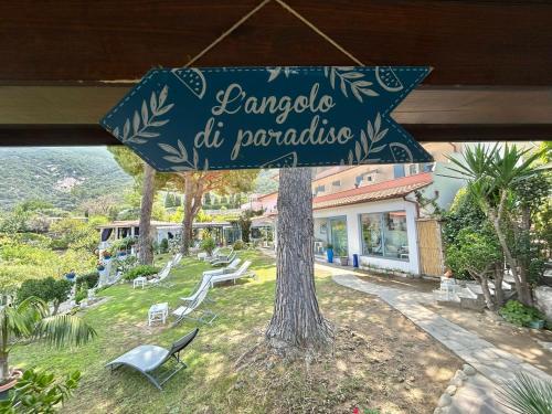 a sign that is hanging from a tree at Hotel Sant'Andrea in Marciana