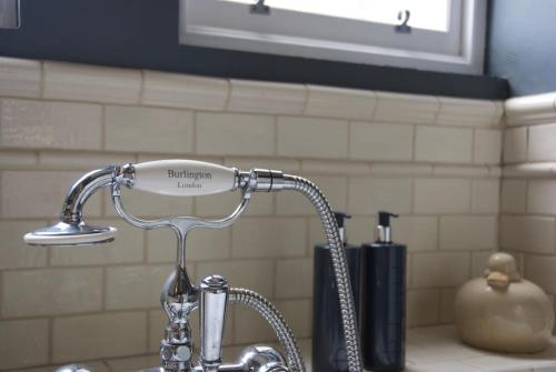 a faucet over a sink in a kitchen at Victorian Apartment with car parking in driveway, Murrayfield in Edinburgh