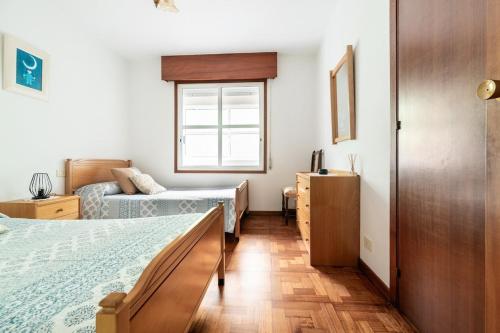 a bedroom with two beds and a window at Escapada as Rías Baixas A Guarda clima genial in A Guarda