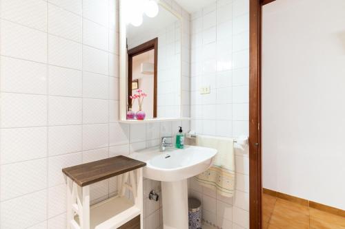 a white bathroom with a sink and a mirror at Escapada as Rías Baixas A Guarda clima genial in A Guarda