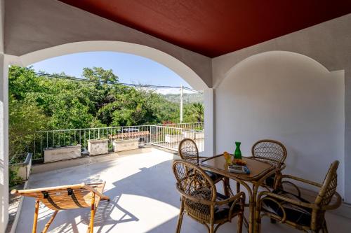 a patio with a table and chairs on a balcony at Holiday Home Mareta in Dubrovnik