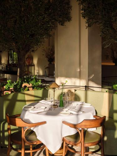 a table with chairs and a white table cloth at Collegio alla Querce, Auberge Collection in Florence