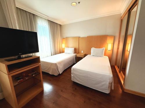Кровать или кровати в номере Blue Tree Premium Morumbi